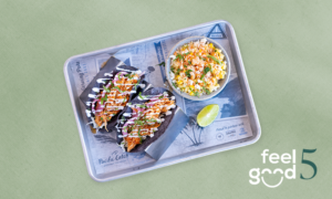 A tray with three tacos topped with greens and sauce, a bowl of rice with vegetables, a lime wedge, and “feel good 5” text on a light green background.